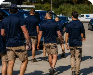 Plumbers walking to their service vans on a Canada Bay job
